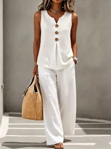 Elegant white linen sleeveless top and wide-leg trousers set featuring button details