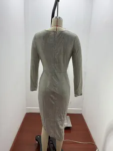Detailed back view of a sparkling silver glittery long-sleeved midi evening dress on a mannequin