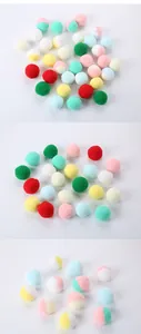 Detailed view of colorful plush cat toy pompoms in solid and dual-tone macaron shades