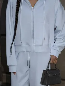 Close-up detail of a light blue two-piece zip-up hoodie and matching sweatpants set