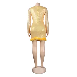 Detailed back view of sexy gold sequin mini dress with yellow feather hem and zipper.