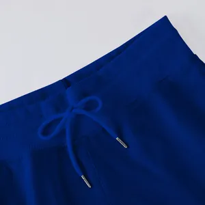 Detailed macro view of the elastic waistband and drawstring on royal blue trousers