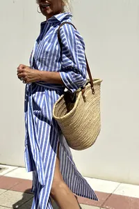 Detail view of blue and white striped shirt dress with lapel collar and side slit
