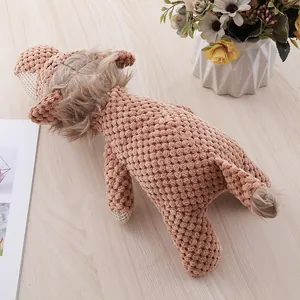 Macro view of textured brown lion plush dog toy resting on a light wooden floor