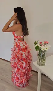 Detail view of floral organza maxi dress showing elegant back cut-out and ruffles.