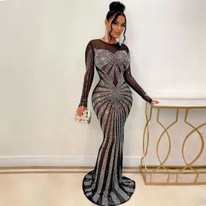 Detailed view of sexy black floor-length dress with sparkling silver rhinestone patterns.