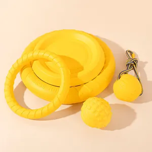 Yellow interactive dog toy set including frisbees, pull ring, and chewing balls