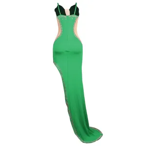 Close-up detail of sexy green evening dress with sparkling rhinestones and mesh panels.