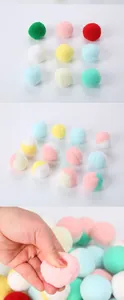 Close-up of soft macaron plush cat toy balls showing dual-color design and texture.