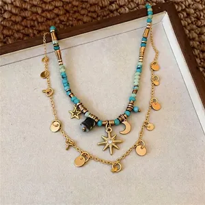 Collana bohémien vintage a doppio strato con pendenti a stella e luna e perline