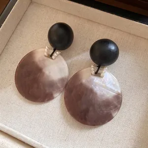 Eleganti orecchini pendenti in acrilico marmorizzato con sfera in legno nero e perle fini