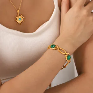 Close-up of a gold titanium steel bracelet with square green zircon on a model