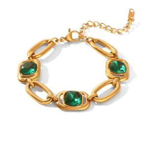 Detailed close-up of a luxury gold titanium steel bracelet with green zircon stones