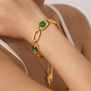Detail shot of a premium gold-plated titanium steel bracelet with green zircon stones