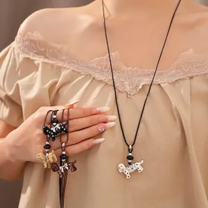 Fashionable polka dot dog pendant necklace with bow and leather cord