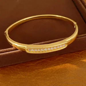 Close-up of 18K gold plated oval bangle featuring sparkling zircon inlay detail