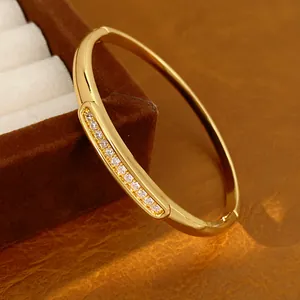 Macro view of a luxury gold-plated oval bangle featuring fine zircon stones inlay