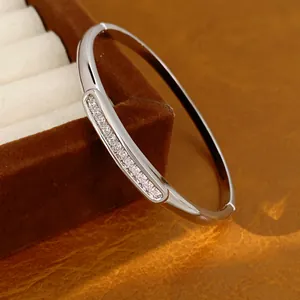 Close-up of elegant 18K gold plated oval bangle with sparkling zircon inlay