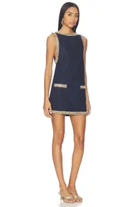Full-length view of navy blue denim mini dress with luxury rhinestone trim detailing.