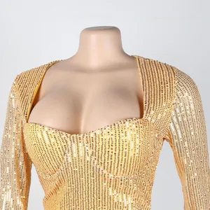 Elegant gold sequined evening dress with square neckline and long sleeves.