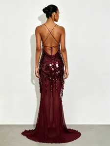 Detailed back view of a sequined burgundy fishtail evening gown with criss-cross straps.