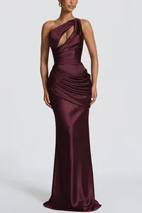 Detail of burgundy satin one-shoulder dress with cutouts and elegant waist pleats.