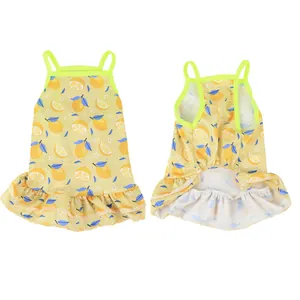 Front and back detail of a yellow pet dress with vibrant lemon pattern and ruffles.