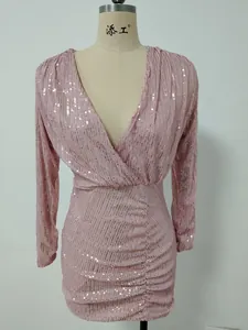 Close-up of elegant pink sequined V-neck cocktail dress with stylish ruched details