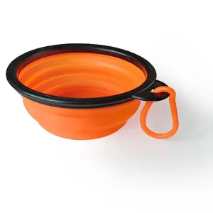 Macro view of portable collapsible orange pet bowl featuring a sturdy black rim