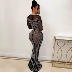 Detailed back view of sexy black mesh maxi dress with intricate rhinestone patterns