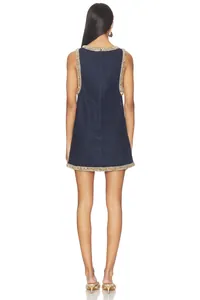 Back view of a sleeveless denim dress with elegant rhinestone trim on neckline and hem