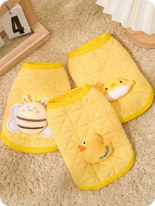 Detailed view of yellow quilted pet vests with bee, chick, and duck animal patches