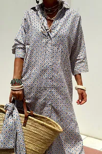 Detail view of a geometric print shirt dress featuring a lapel and button design