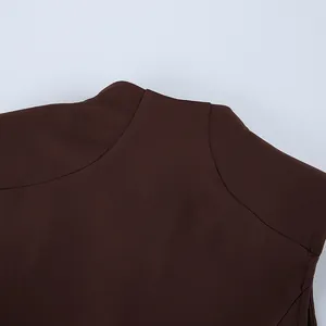 Close-up of the elegant round neckline and fabric texture of a brown French retro dress.
