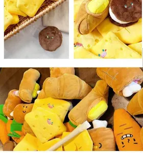 Varietà di giocattoli di peluche per cani a forma di formaggio, croissant e carote.