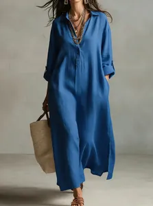 Full-length view of a navy blue cotton linen shirt dress with a relaxed fit and side slits.
