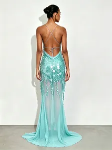 Back view of elegant mint green sequined mermaid evening gown with thin straps and open back