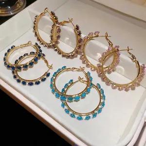Elegant gold-plated hoop earrings with sparkling multi-color cubic zirconia stones.