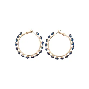 Modern gold-tone hoop earrings decorated with sparkling blue triangular cubic zirconia.