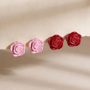 Macro detail of elegant pink and red enamel rose earrings with 18k gold plated stainless steel