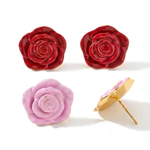 Close-up of elegant red and pink enamel rose earrings with gold-plated backing details