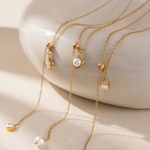 Detailed view of 18k gold plated stainless steel lariat necklaces with pearl and zircon charms
