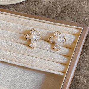 Gros plan de boucles d'oreilles fleurs plaquées or 18k avec perles et zircons fins