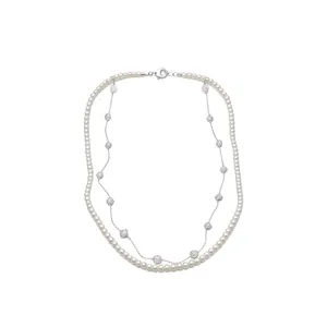 Elegant double-layered necklace featuring classic pearls and shimmering crystal pendants.