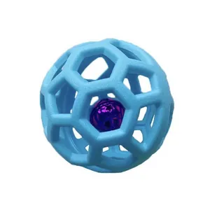 Detail of a blue hollow TPR dog toy ball with an internal purple bell for teething.