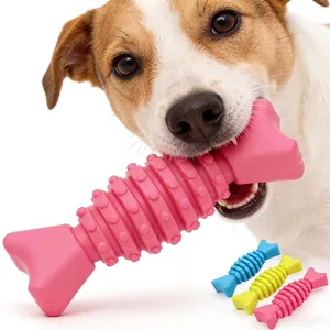 Close-up of a dog biting a pink TPR fishbone-shaped chew toy for dental cleaning.