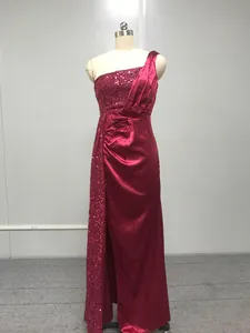 Professional view of a burgundy one-shoulder sequined evening gown displayed on a mannequin