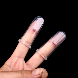 Soft transparent silicone finger toothbrushes for pets shown on human fingers for cats