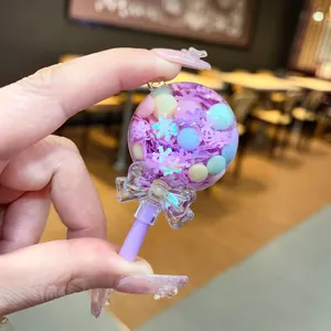 Close-up of purple lollipop liquid sand shaker charm with snowflake glitter and pastel beads