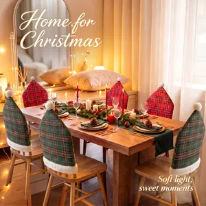 Festive plaid Christmas chair covers with pom poms in a cozy warm holiday dining room